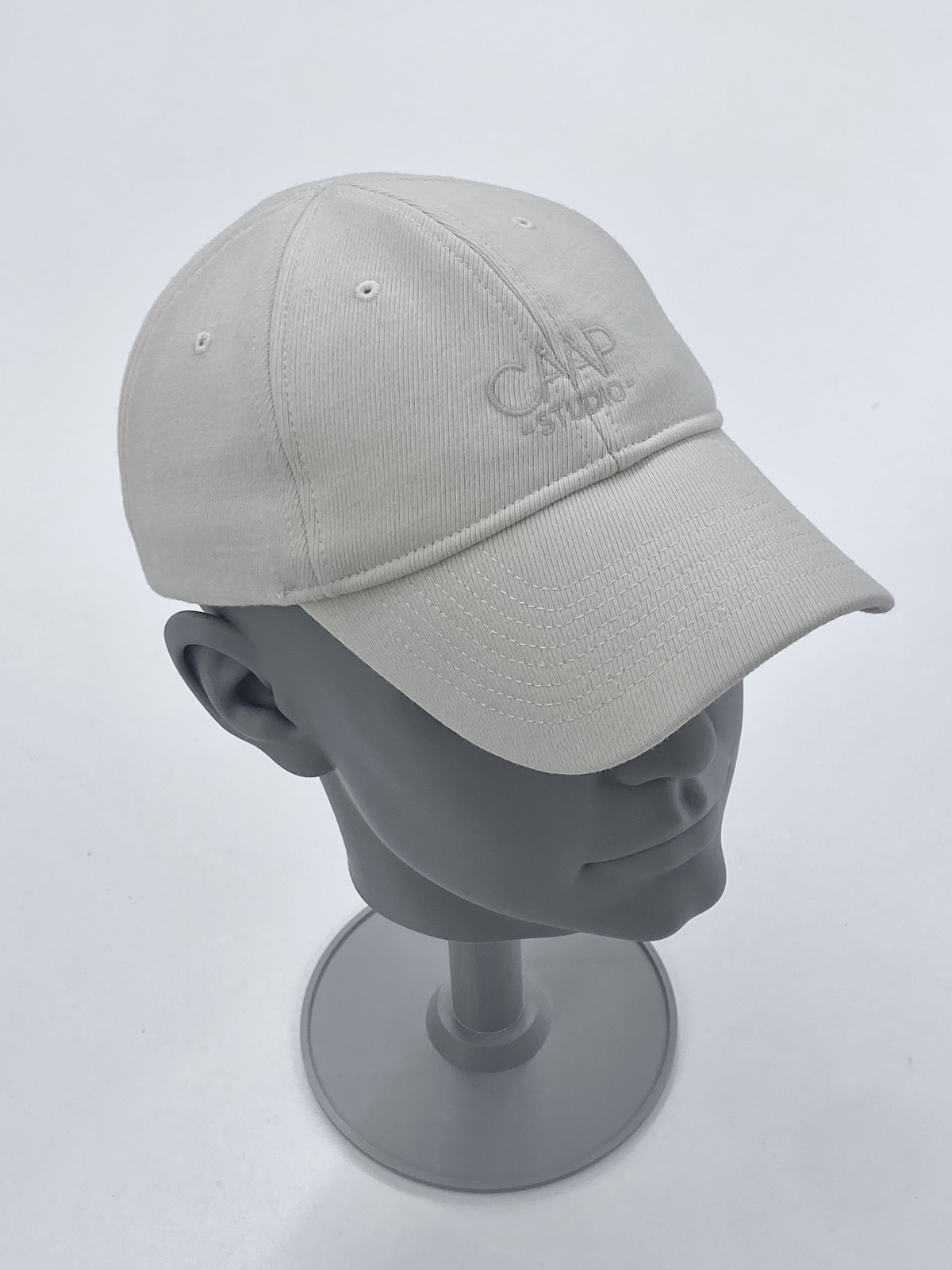 White cap sample on a display stand