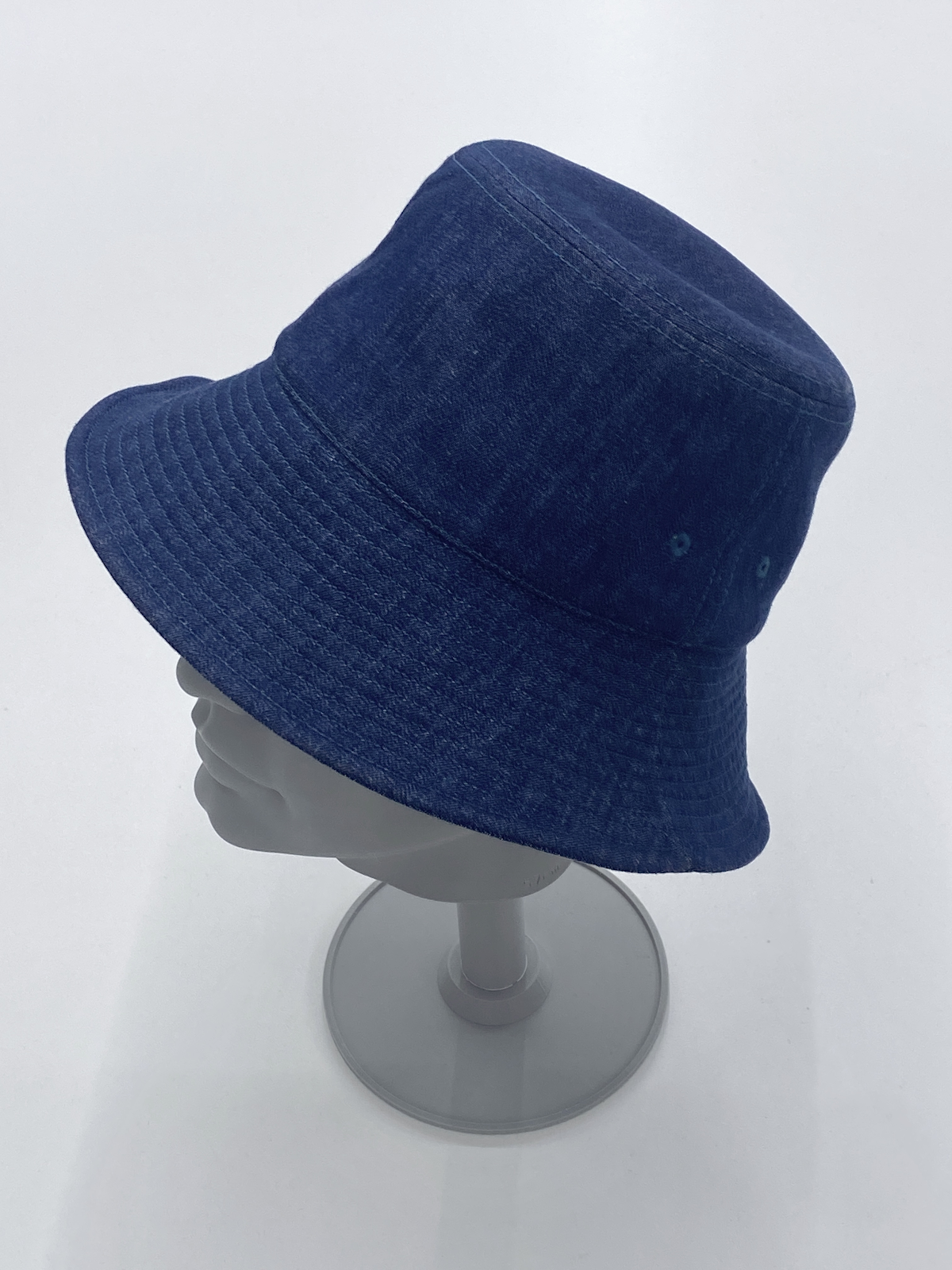 Blue bucket hat sample on a display stand